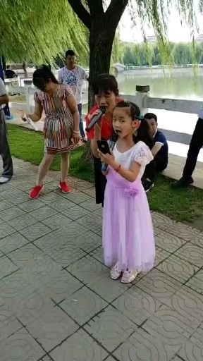 母女俩在华新镇人民公园一起合唱